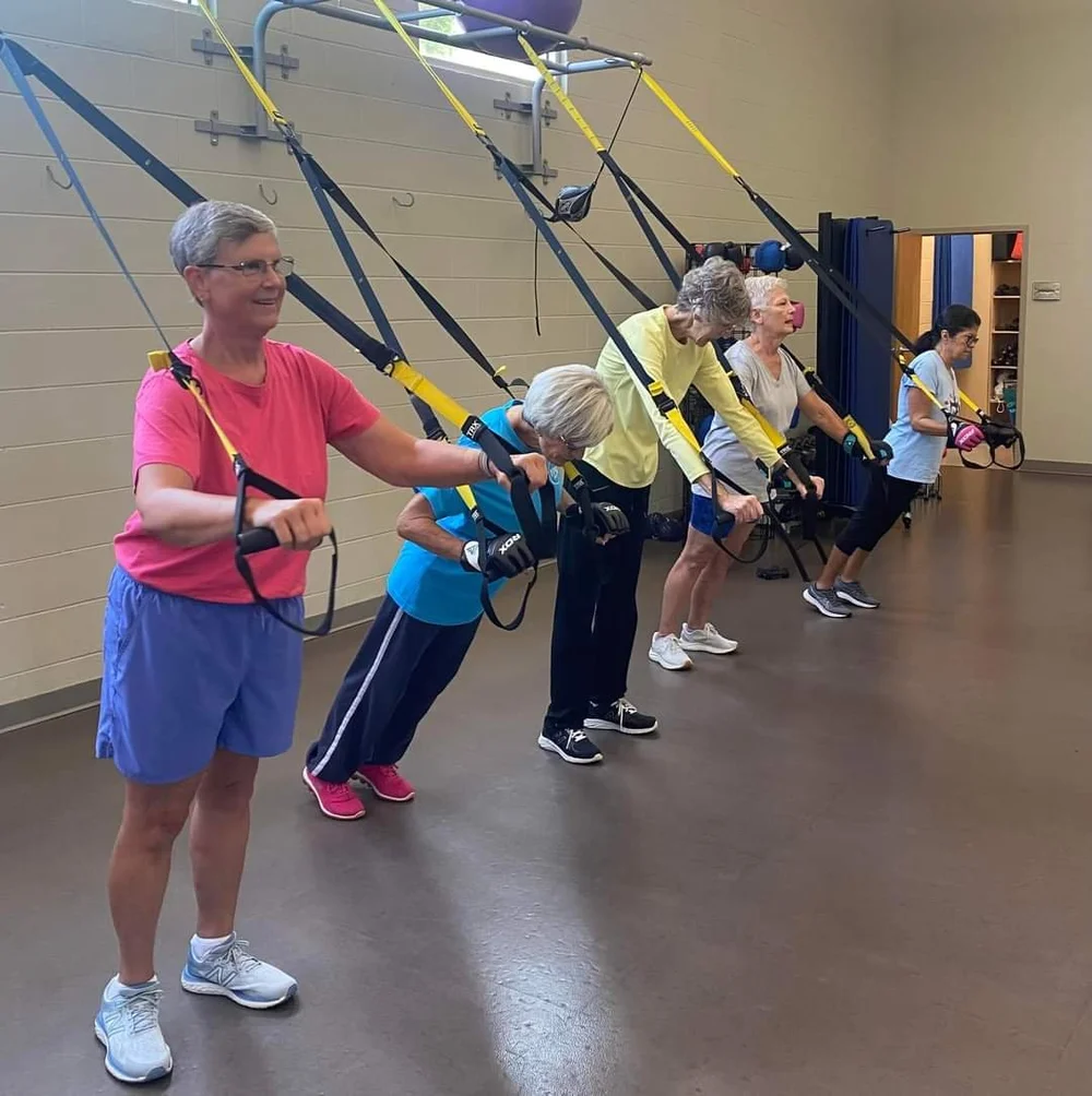 Members using TRX straps in class